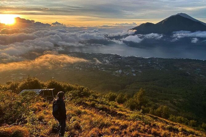Mount Batur Sunrise Trekking With Local Guide - Sunrise, clouds, and the volcanic setting